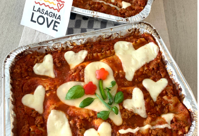 Lasagna topped with heart shaped cheese and basil flowers