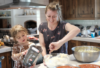 Woman and child in kitchen cooking